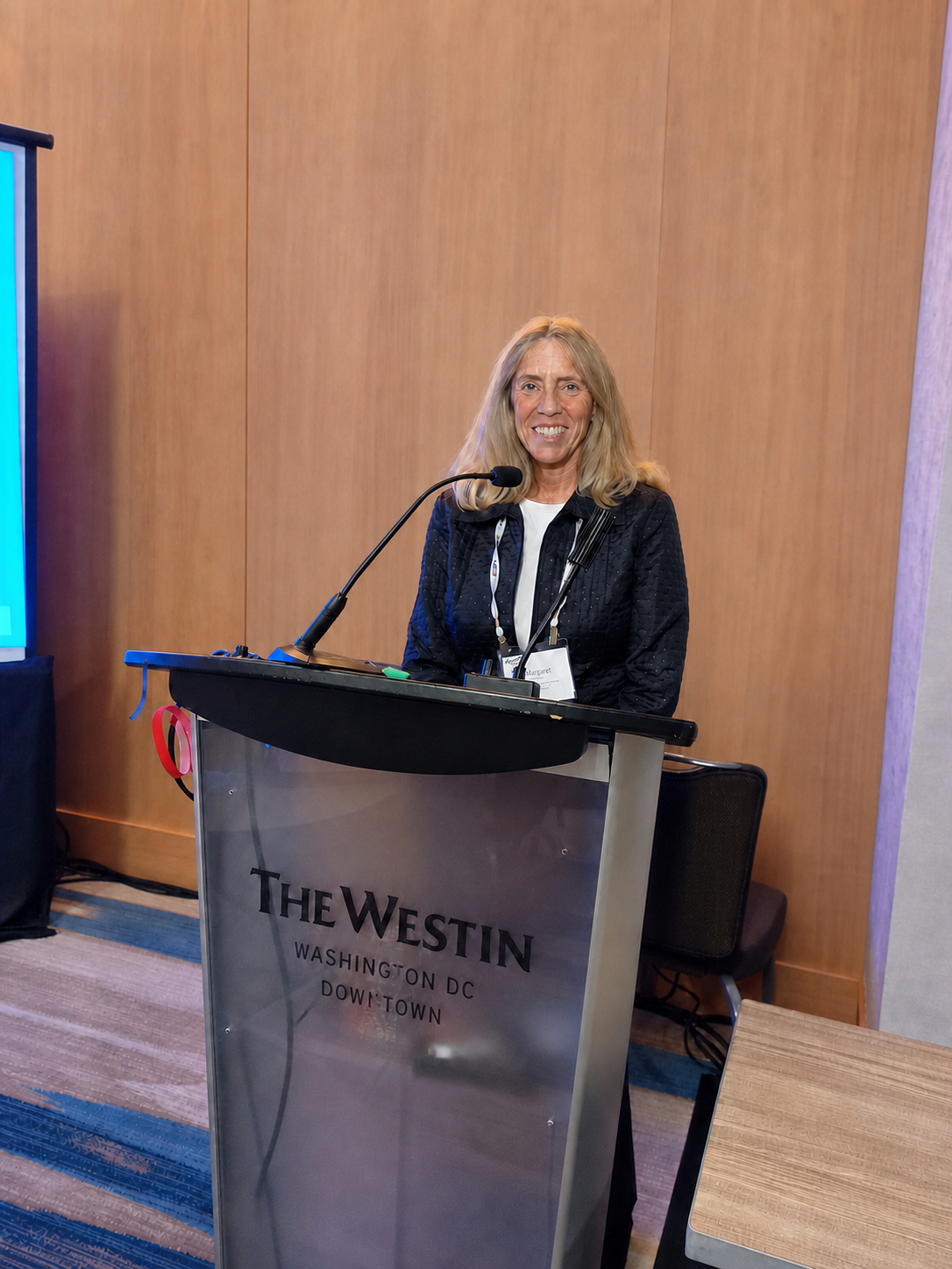 Margaret A. Johnsson speaking at a conference podium